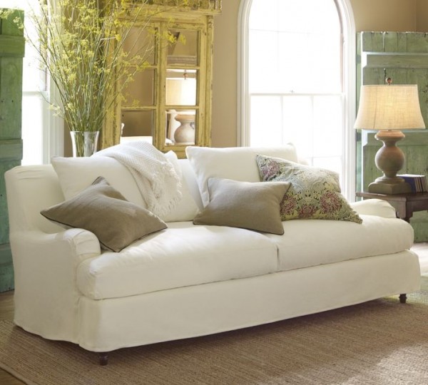 A traditional English roll arm couch with slipcovers from Pottery Barn.