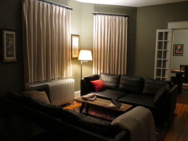 AFTER: Our night-time living room after painting, installing drapes, and adding a lamp