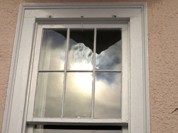 Antique wavy glass can be bought to replace glass in old wooden windows