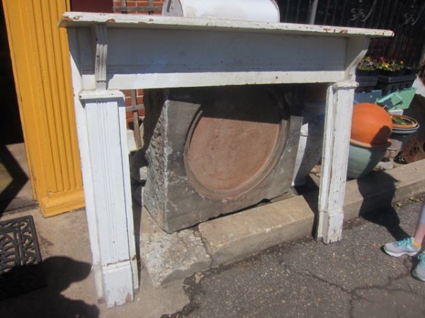 A salvaged fireplace mantel that was rehabbed and used in a living room remodel