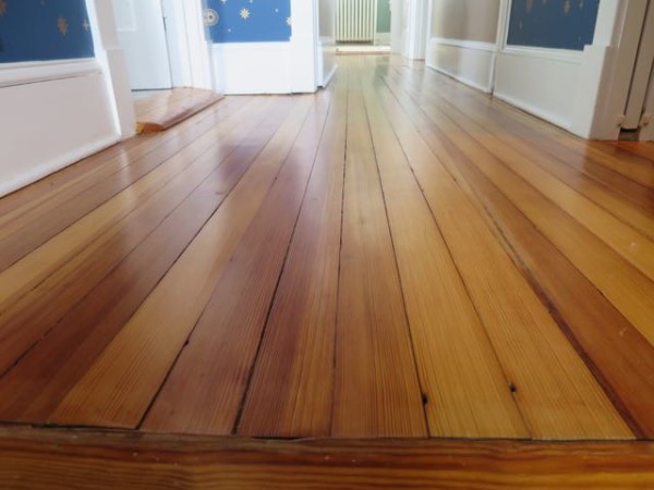 Reclaimed pine flooring was used to match and replace flooring that was destroyed in a renovation