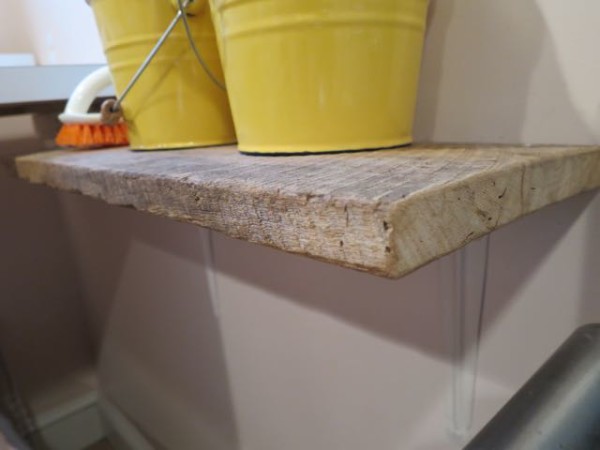 Slabs of wood found in an old barn were used to make shelves in a laundry room