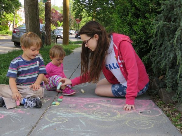 Sofia doing sidewalk drawings with Luke and Diana.