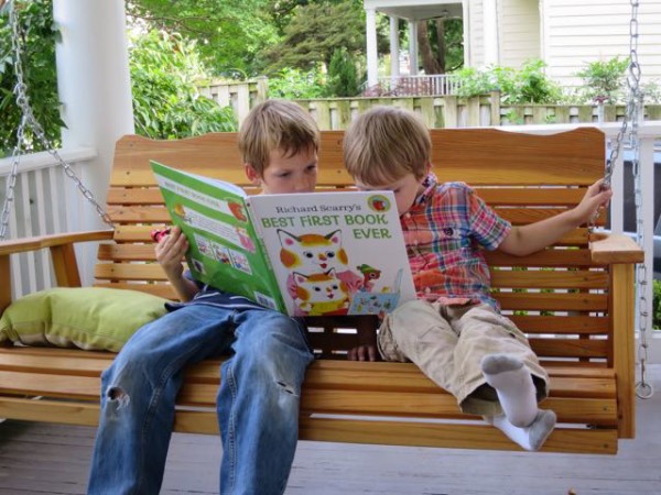 Mark and Luke reading a book on our new porch swing.